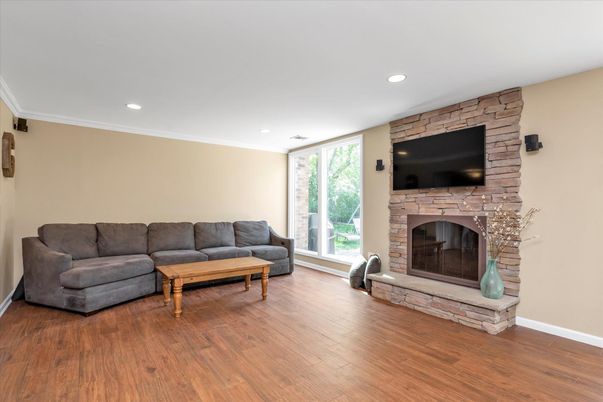 Fireplace, Interior, Living room, Recessed Lighting, Stone Walls, Wood Texture Flooring