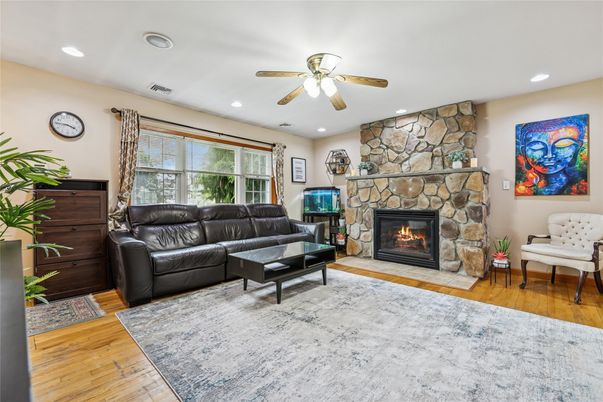 Fireplace, Interior, Living room, Recessed Lighting, Stone Walls, Wood Texture Flooring
