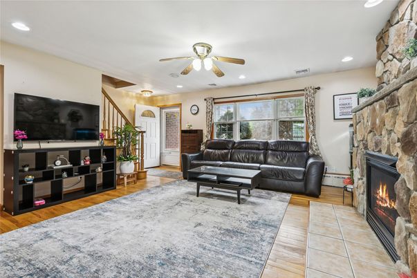 Fireplace, Interior, Living room, Recessed Lighting, Stone Walls, Wood Texture Flooring