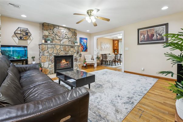 Dining room, Fireplace, Interior, Living room, Recessed Lighting, Stone Walls, Wood Texture Flooring