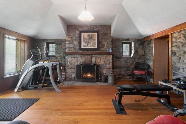 Fireplace, Fitness Equipment, Interior, Pendant Lights, Stone Walls, Wood Texture Flooring