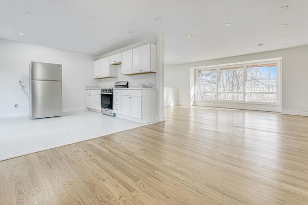 Empty room, Interior, Kitchen, Recessed Lighting, Stainless Steel Appliances, Wood Texture Flooring
