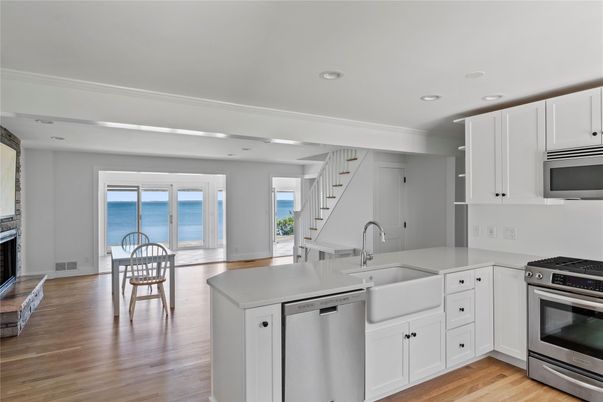 Dining room, Fireplace, Interior, Kitchen, Recessed Lighting, Stainless Steel Appliances, Water, Wood Texture Flooring