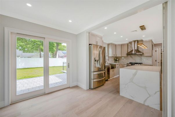 Interior, Kitchen, Marble Walls, Recessed Lighting, Stainless Steel Appliances, Wood Texture Flooring
