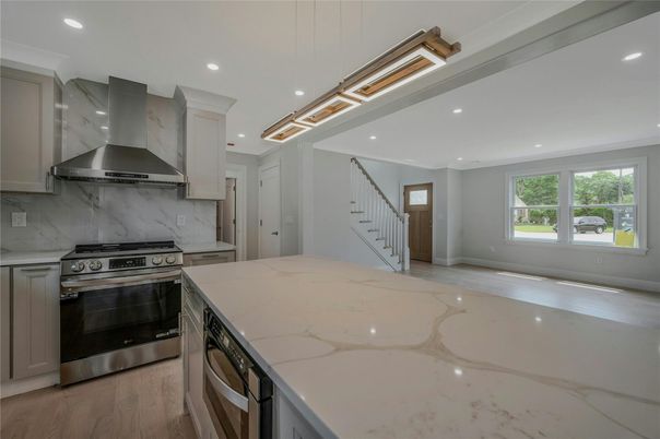 Interior, Kitchen, Marble Walls, Recessed Lighting, Stainless Steel Appliances, Wood Texture Flooring