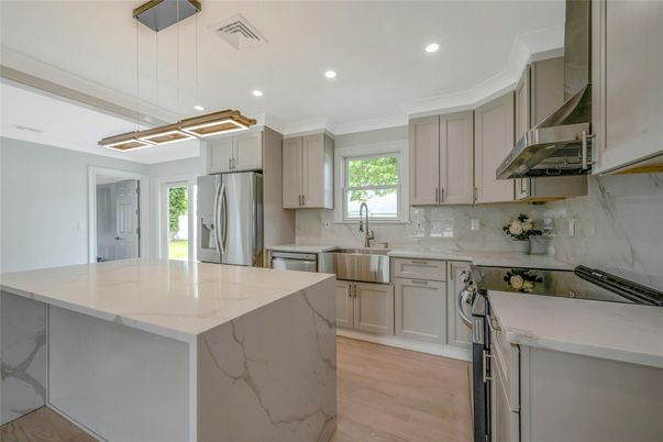 Interior, Kitchen, Marble Walls, Pendant Lights, Recessed Lighting, Stainless Steel Appliances, Wood Texture Flooring