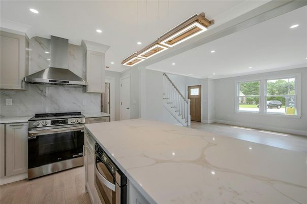 Interior, Kitchen, Marble Walls, Recessed Lighting, Stainless Steel Appliances, Wood Texture Flooring