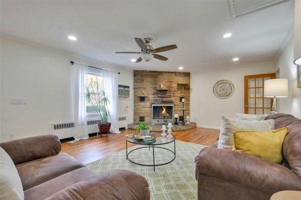 Fireplace, Interior, Living room, Recessed Lighting, Stone Walls, Wood Texture Flooring