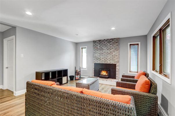 Fireplace, Interior, Living room, Recessed Lighting, Stone Walls, Wood Texture Flooring