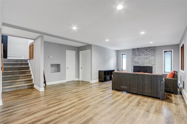 Fireplace, Interior, Living room, Recessed Lighting, Stone Walls, Wood Texture Flooring