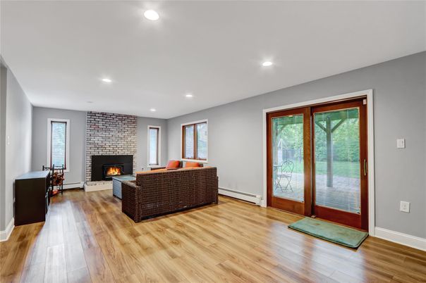 Fireplace, Interior, Living room, Recessed Lighting, Stone Walls, Wood Texture Flooring