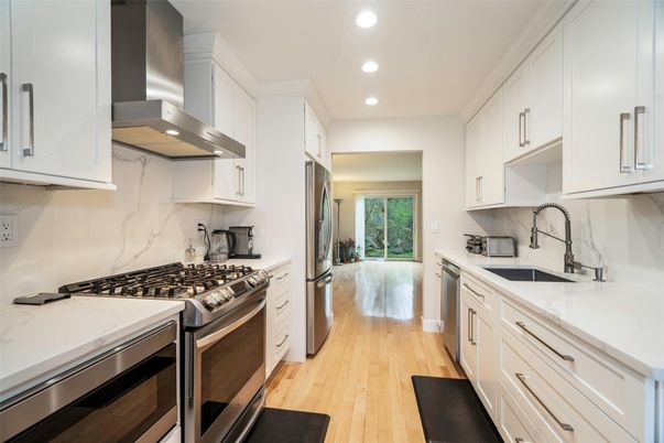 Interior, Kitchen, Marble Walls, Recessed Lighting, Stainless Steel Appliances, Wood Texture Flooring