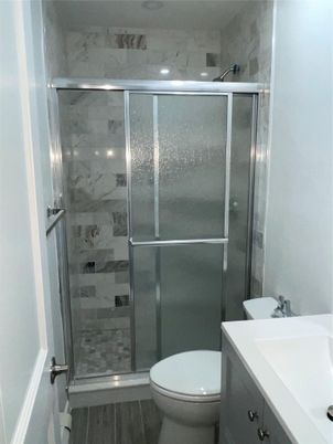 Bathroom, Glass Shower, Interior, Marble Walls, Recessed Lighting, Wood Texture Flooring