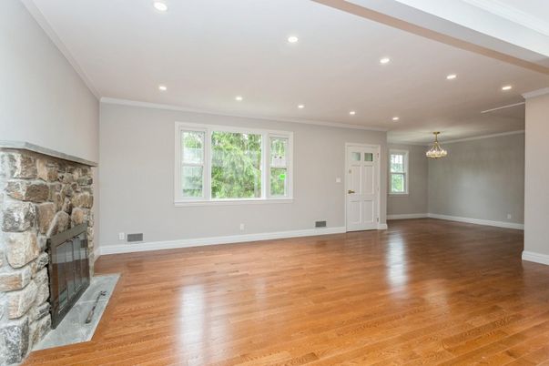 Chandelier, Empty room, Fireplace, Interior, Recessed Lighting, Stone Walls, Wood Texture Flooring