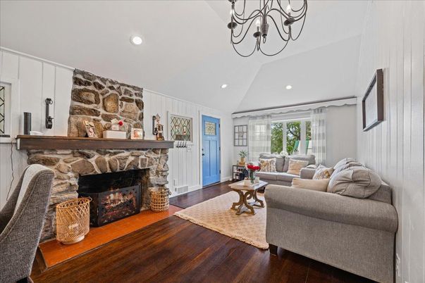 Chandelier, Fireplace, Interior, Living room, Recessed Lighting, Stone Walls, Wood Texture Flooring