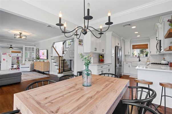 Chandelier, Dining room, Interior, Kitchen, Living room, Pendant Lights, Recessed Lighting, Stainless Steel Appliances, Wood Texture Flooring