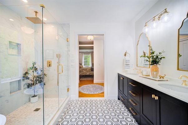 Bathroom, Dual Sink Vanities, Glass Shower, Interior, Marble Walls, Recessed Lighting, Wood Texture Flooring