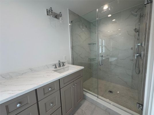 Bathroom, Dual Sink Vanities, Glass Shower, Interior, Marble, Marble Walls, Recessed Lighting