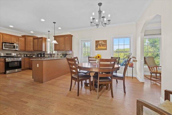Chandelier, Dining room, Interior, Kitchen, Pendant Lights, Recessed Lighting, Stainless Steel Appliances, Wood Texture Flooring