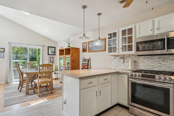 Dining room, Interior, Kitchen, Pendant Lights, Recessed Lighting, Stainless Steel Appliances, Wood Texture Flooring