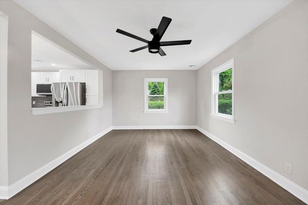 Empty room, Interior, Kitchen, Recessed Lighting, Stainless Steel Appliances, Wood Texture Flooring