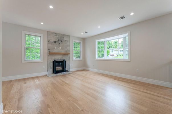 Empty room, Fireplace, Interior, Marble Walls, Recessed Lighting, Wood Texture Flooring