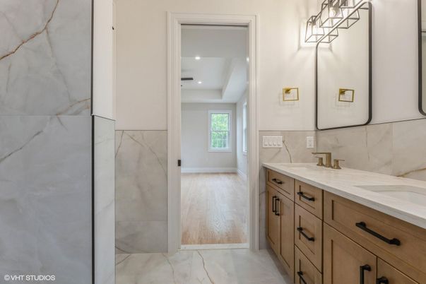 Bathroom, Dual Sink Vanities, Interior, Marble, Marble Walls, Recessed Lighting, Wood Texture Flooring