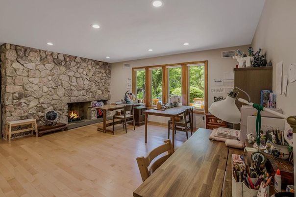Dining room, Fireplace, Interior, Recessed Lighting, Stone Walls, Wood Texture Flooring