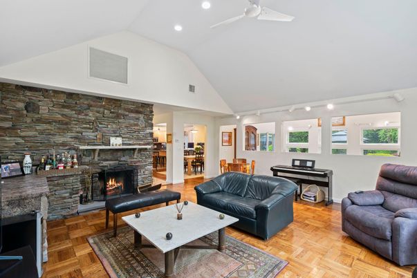 Fireplace, Interior, Living room, Piano, Recessed Lighting, Stone Walls, Wood Texture Flooring