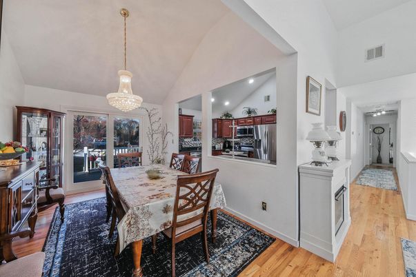 Chandelier, Dining room, Interior, Kitchen, Pendant Lights, Recessed Lighting, Stainless Steel Appliances, Wood Texture Flooring