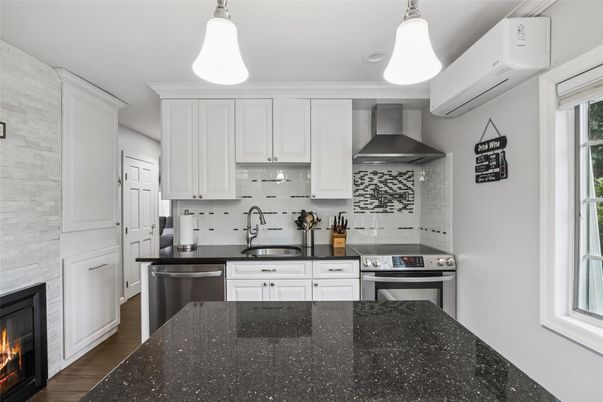 Fireplace, Interior, Kitchen, Pendant Lights, Stainless Steel Appliances, Stone Walls, Wood Texture Flooring