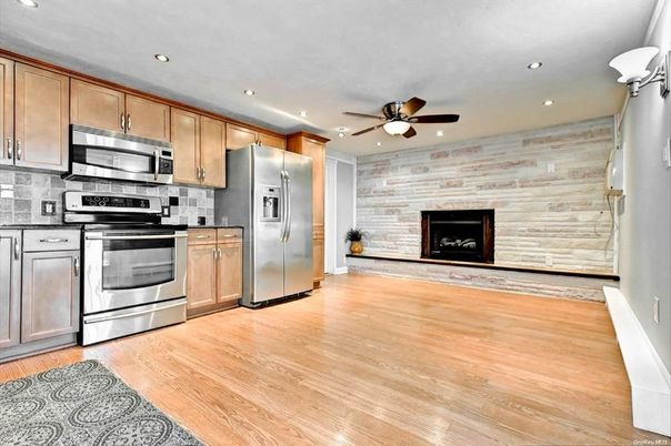 Fireplace, Interior, Kitchen, Recessed Lighting, Stainless Steel Appliances, Stone Walls, Wood Texture Flooring