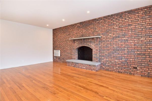 Empty room, Fireplace, Interior, Recessed Lighting, Stone Walls, Wood Texture Flooring