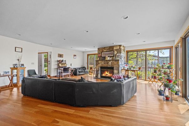 Fireplace, Interior, Living room, Recessed Lighting, Stone Walls, Wood Texture Flooring