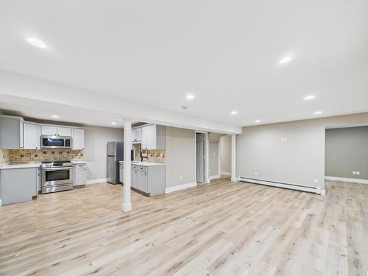 Empty room, Interior, Kitchen, Recessed Lighting, Stainless Steel Appliances, Wood Texture Flooring