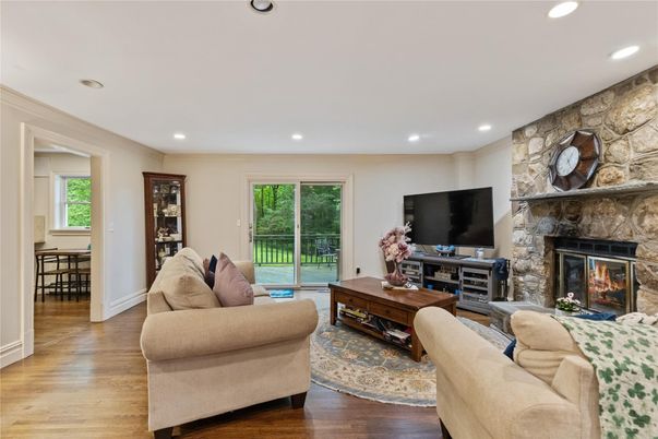 Fireplace, Interior, Living room, Recessed Lighting, Stone Walls, Wood Texture Flooring