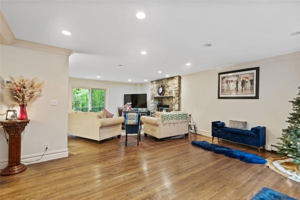Fireplace, Interior, Living room, Recessed Lighting, Stone Walls, Wood Texture Flooring