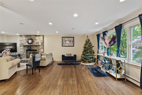 Fireplace, Interior, Living room, Recessed Lighting, Stone Walls, Wood Texture Flooring