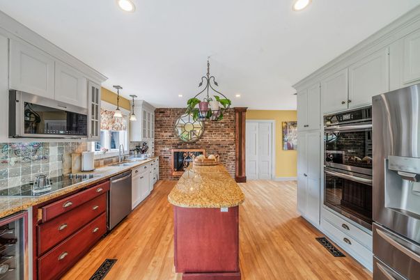 Fireplace, Interior, Kitchen, Pendant Lights, Recessed Lighting, Stainless Steel Appliances, Stone Walls, Wood Texture Flooring