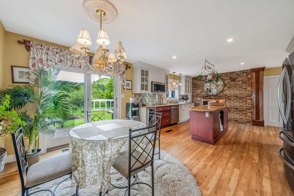 Chandelier, Dining room, Interior, Kitchen, Recessed Lighting, Stainless Steel Appliances, Stone Walls, Wood Texture Flooring