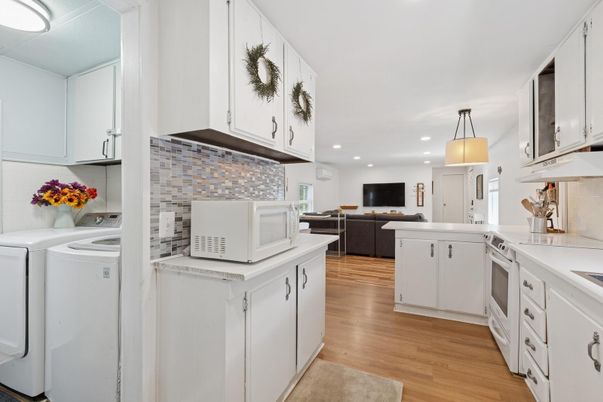 Interior, Kitchen, Recessed Lighting, Washer, Wood Texture Flooring