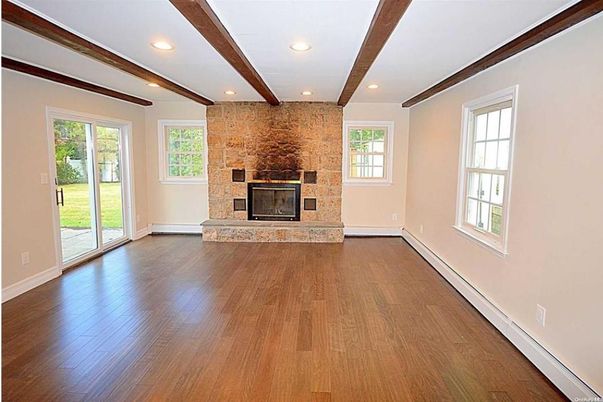 Empty room, Fireplace, Interior, Recessed Lighting, Stone Walls, Wooden Beams, Wood Texture Flooring