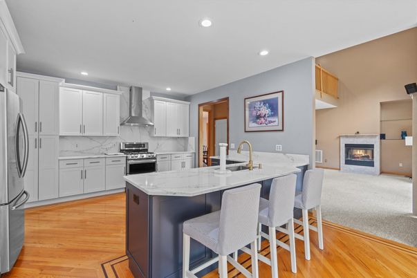 Fireplace, Interior, Kitchen, Marble Walls, Recessed Lighting, Stainless Steel Appliances, Wood Texture Flooring