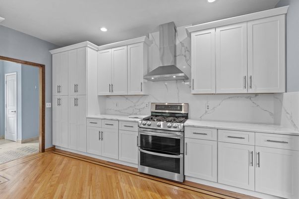 Interior, Kitchen, Marble Walls, Recessed Lighting, Stainless Steel Appliances, Wood Texture Flooring