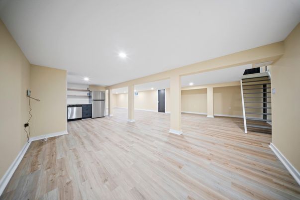 Empty room, Interior, Kitchen, Recessed Lighting, Stainless Steel Appliances, Wood Texture Flooring