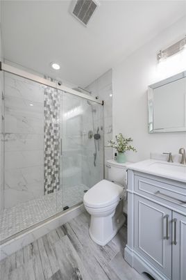 Bathroom, Glass Shower, Interior, Marble Walls, Recessed Lighting, Wood Texture Flooring