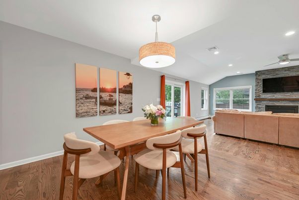 Dining room, Fireplace, Interior, Living room, Recessed Lighting, Stone Walls, Wood Texture Flooring