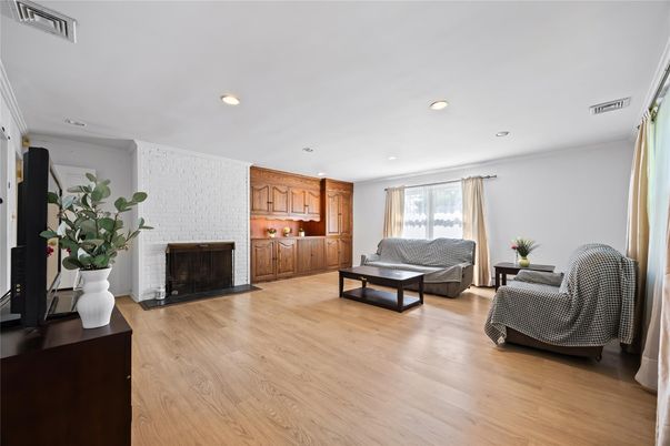 Fireplace, Interior, Living room, Recessed Lighting, Stone Walls, Wood Texture Flooring