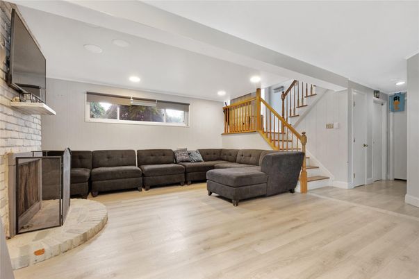 Fireplace, Interior, Living room, Recessed Lighting, Stone Walls, Wood Texture Flooring
