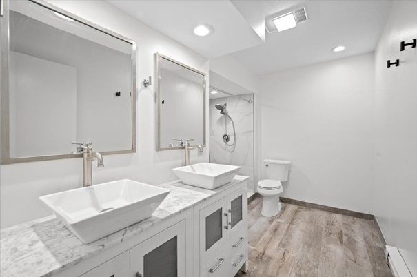 Bathroom, Dual Sink Vanities, Free Standing Baths, Interior, Marble Walls, Recessed Lighting, Wood Texture Flooring